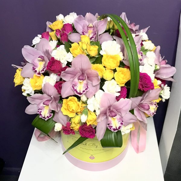 Orchids and spray roses in a medium signature box